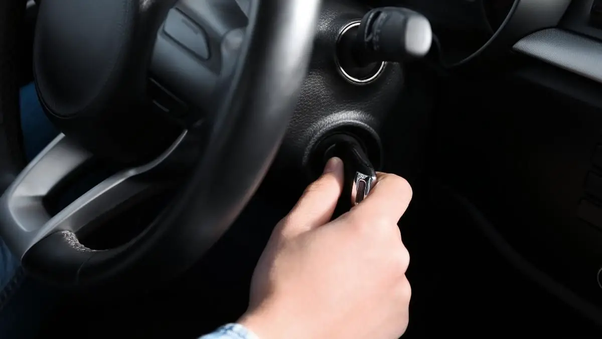 a man trying to remove a key stuck in ignition